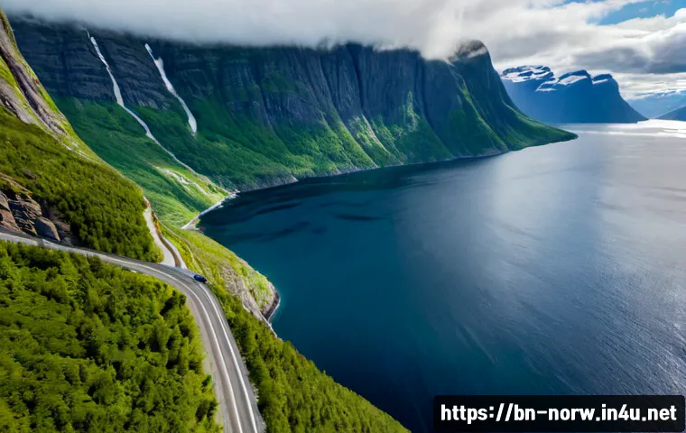 노르웨이의 베스트 드라이브 루트 - Photorealistic aerial view of a classic scenic drive through the Norwegian fjords, a small unbranded...